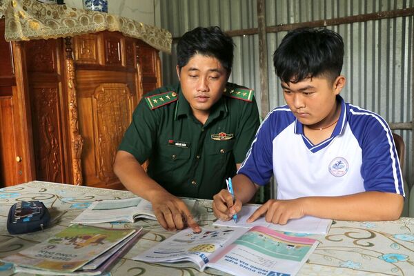 Green-uniformed border guards - familiar presence among coastal residents of Vinh Long